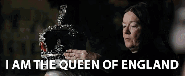 a woman is putting a crown on a man .
