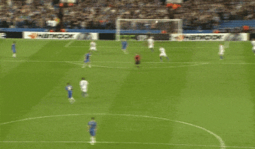 a soccer game is being played on a field with a hankook ad in the background
