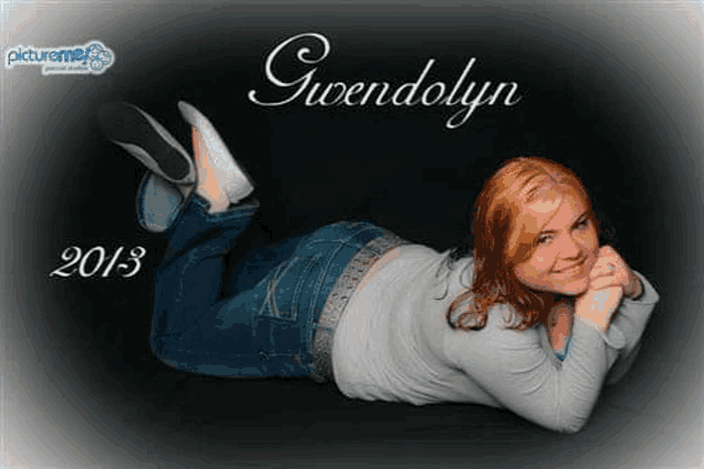 a woman is laying on her stomach on a black background and smiling for a picture .