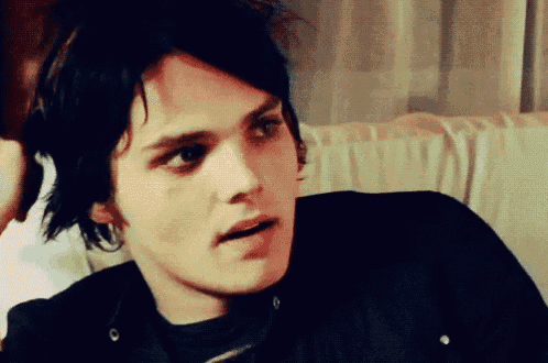 a close up of a young man 's face with a serious look on his face
