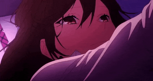 a close up of a girl crying in a purple room .