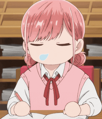 a girl with pink hair is sitting at a desk with a pen in her hand