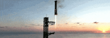 a rocket is being launched from a tower over the ocean