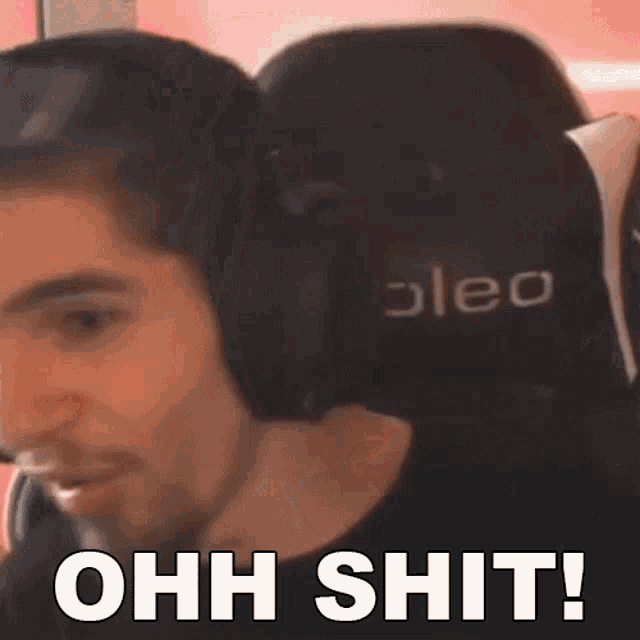 a man wearing headphones with the words ohh shit written below him