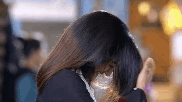 a close up of a woman 's hair blowing in the wind