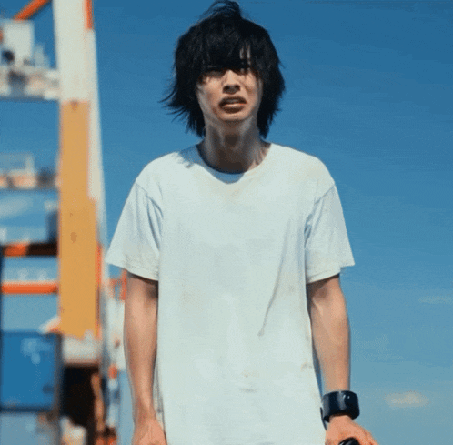 a young man wearing a white t-shirt and a black watch