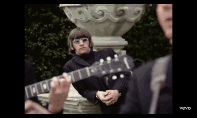 a man playing a guitar in a video that says vevo at the bottom