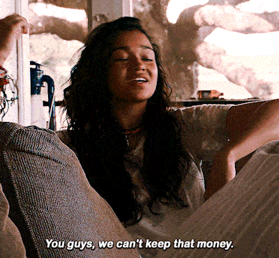 a woman says " you guys we can 't keep that money " while sitting on a couch