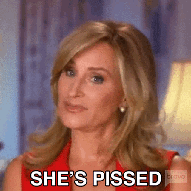 a woman says she 's pissed while wearing a red dress