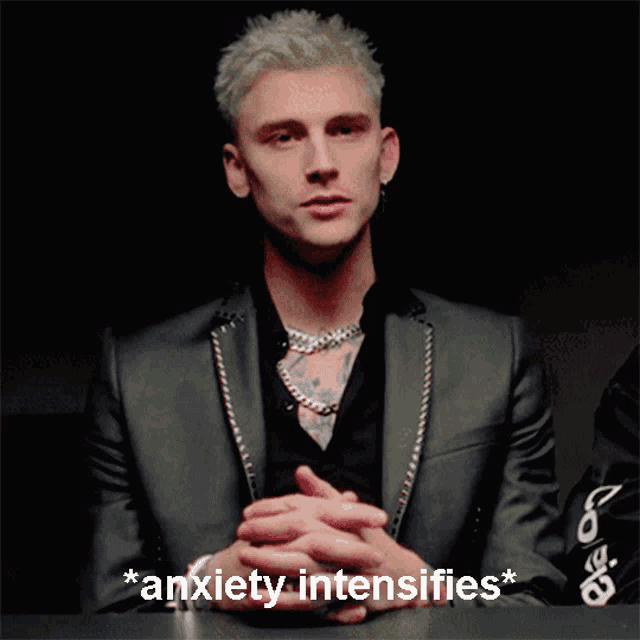 a man in a suit with the words * anxiety intensifies * written below him