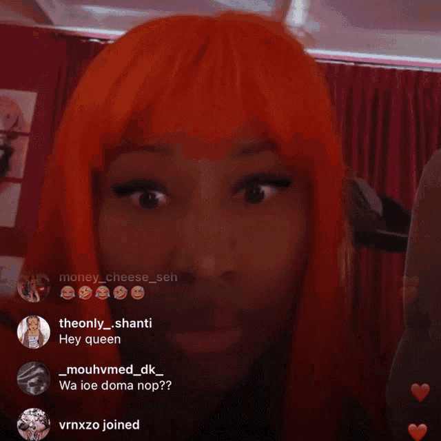 a woman with orange hair is looking at the camera and says hey queen in the upper right corner