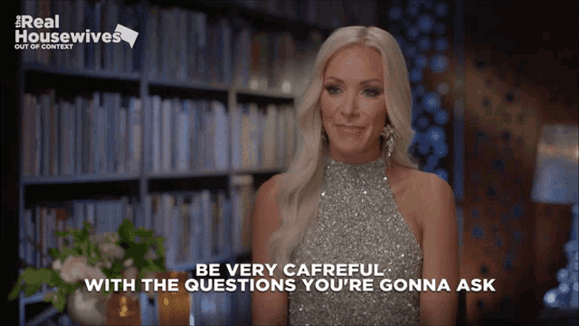 a woman in a silver dress says be very careful with the questions you 're going ask