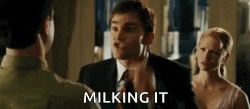 a man in a suit and tie is talking to a woman in a wedding dress .
