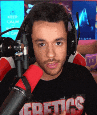 a man wearing headphones and a t-shirt that says eretics