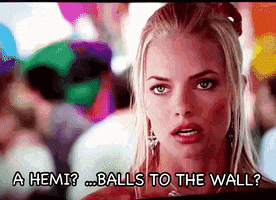 a woman says " a hemi balls to the wall " in front of balloons
