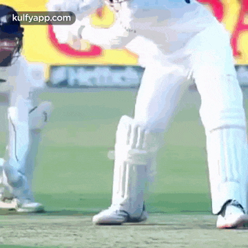 a close up of a cricket player 's legs with a kulfyapp.com logo in the corner