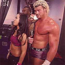 a man and a woman are standing next to each other and the man is wearing a dz belt