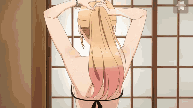 a woman in a bikini is standing in front of a window