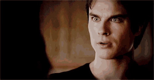 a close up of a man 's face with a surprised expression