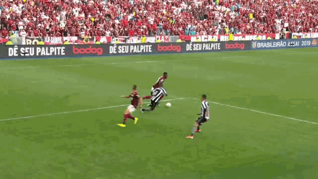 a soccer game is being played in a stadium with a bodog.net ad in the corner