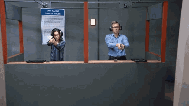 a man and a woman are shooting guns at a gun range