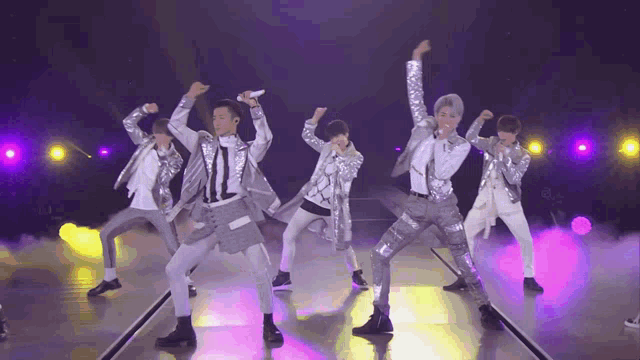 a group of young men are performing on stage