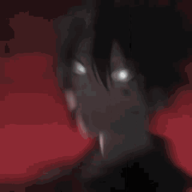 a blurry picture of a person 's face with a red background and a window in the background .