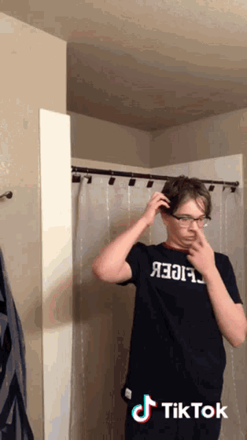 a man wearing glasses and a shirt that says ' abercrombie & fitch ' on it