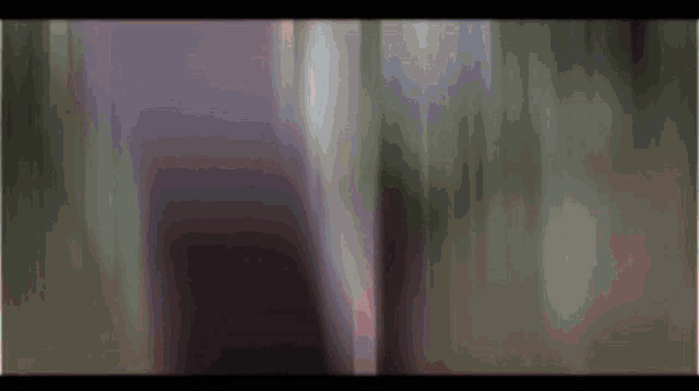 a blurred image of a person in a dark room