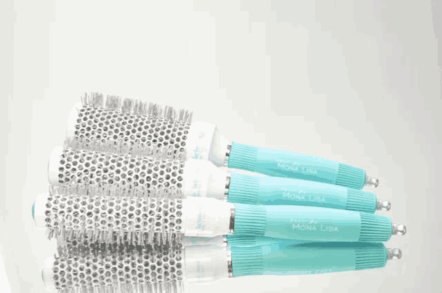 a bunch of mona lisa hair brushes stacked on top of each other