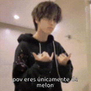 a man in a black hoodie is making a heart shape with his hands and the words `` pov eres únicamente de melon '' .