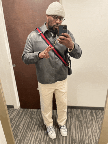 a man is taking a picture of himself in the mirror