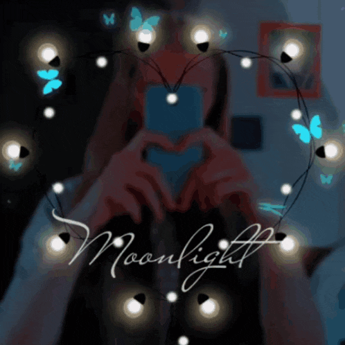 a girl is making a heart shape with her hands and the word moonlight is on the bottom