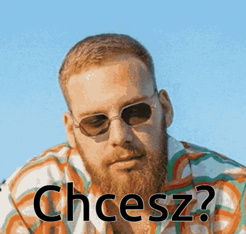 a man with a beard wearing sunglasses and a shirt that says chcesz on it