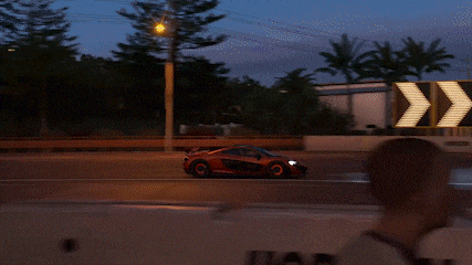 a blurred image of a car driving down a road with arrows pointing to the right