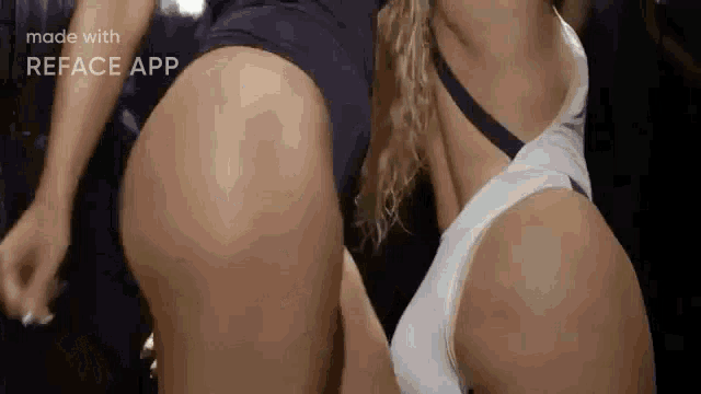 a couple of women are standing next to each other and one of them is wearing a white tank top .
