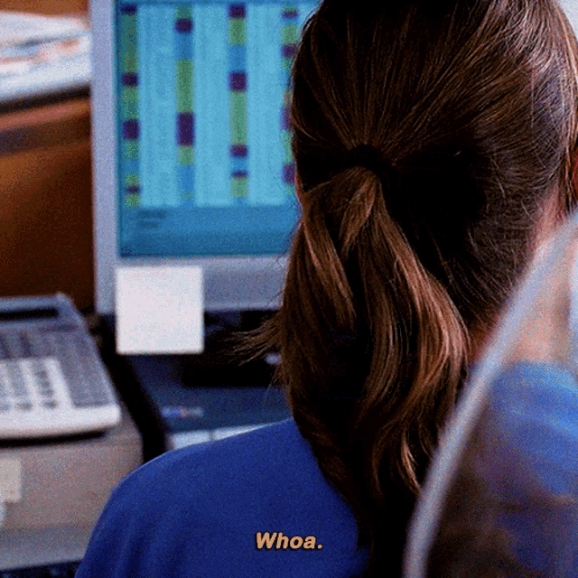 a woman wearing a blue shirt with the word whoa on it