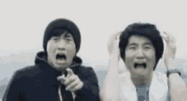 two men are standing next to each other making funny faces .