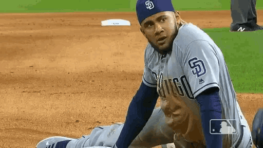 a baseball player with the letter s on his hat is stretching on the field
