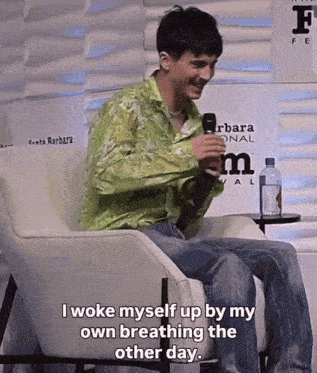 a man sitting in a chair with the words i woke myself up by my own breathing