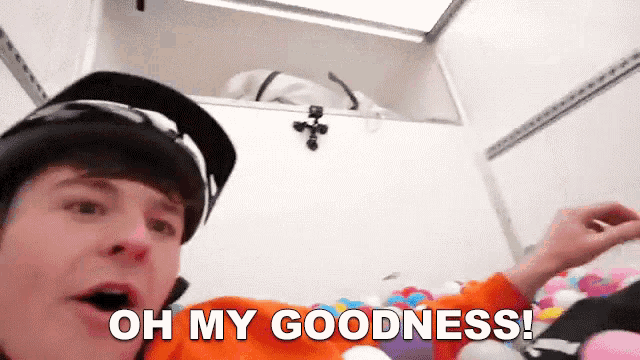 a man wearing a helmet says " oh my goodness " while playing with balloons