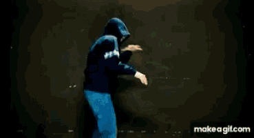 a man in a green shirt is pulling another man in a blue hoodie
