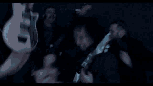 a blurry photo of a man playing a guitar