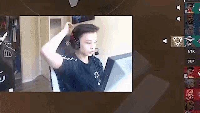 a man wearing headphones is sitting in a chair in front of a computer screen .