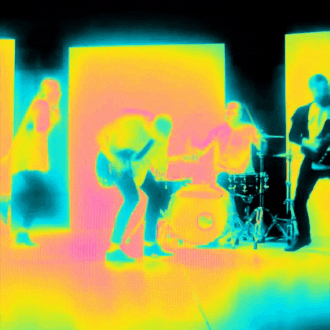 a group of people playing instruments in front of a drum set
