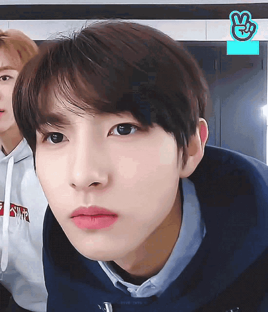 a close up of a person 's face with a vlive logo in the corner