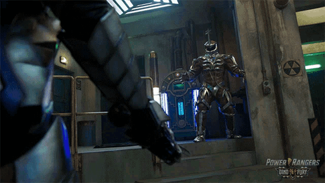 two power rangers are fighting in a room