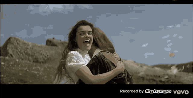 two women hugging each other with the words recorded by mobizen vevo on the bottom