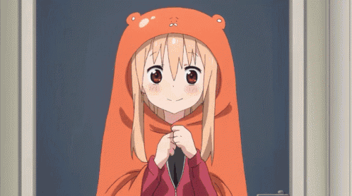 a girl wearing an orange bear hat is standing in a doorway with her hands folded