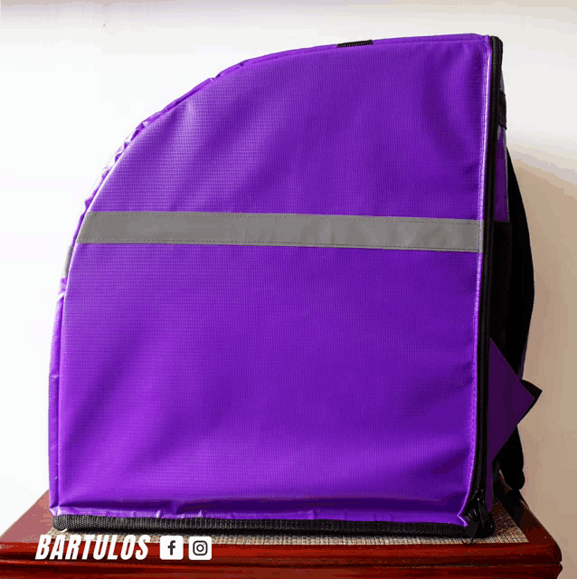 a purple bag that says bartulos on the bottom of it